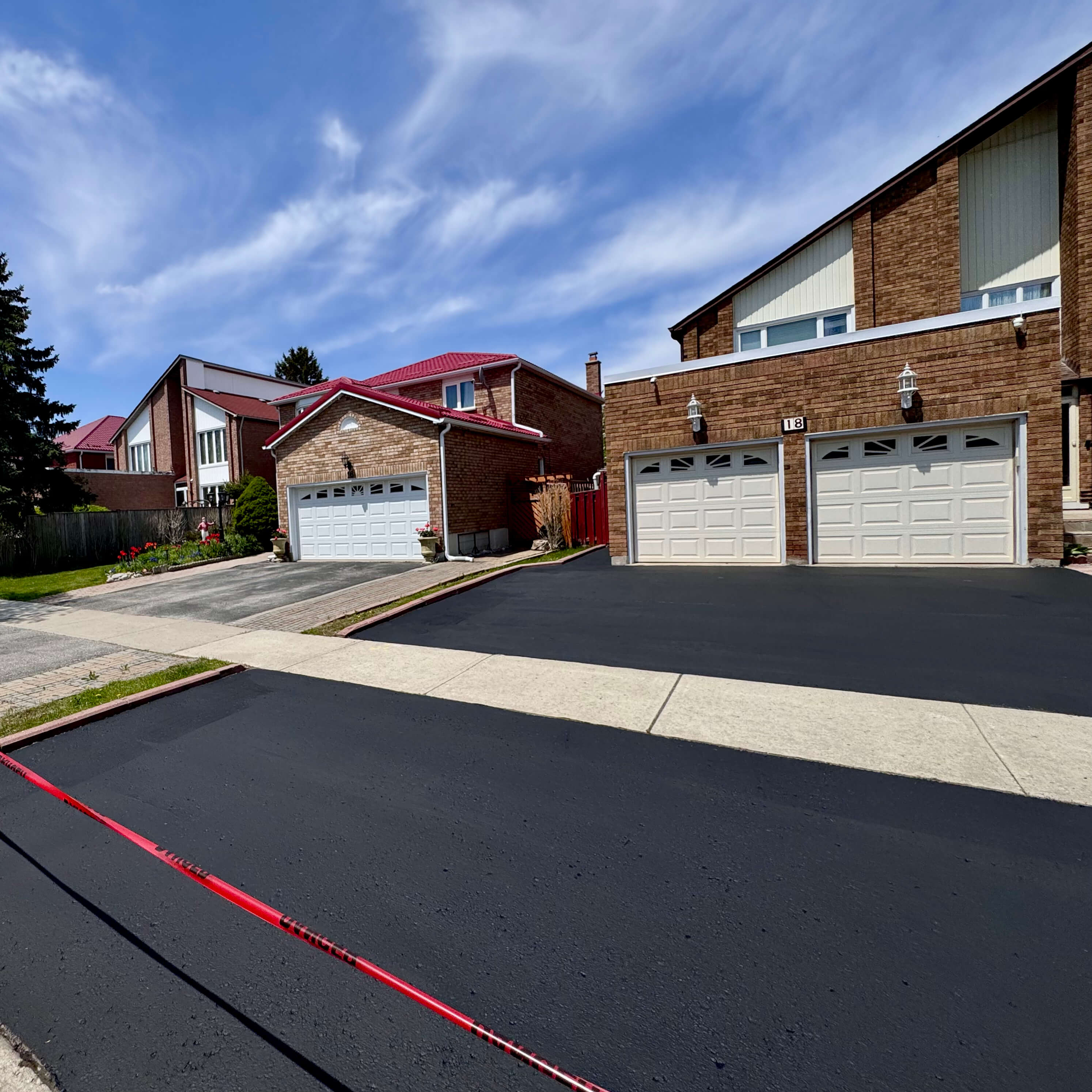 After driveway sealing in Mississauga with clean black asphalt finish